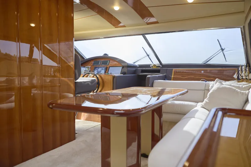 Yacht Photos Pics Luxurious interior of a 2004 Ferretti Yachts 680 with polished wood and plush seating.