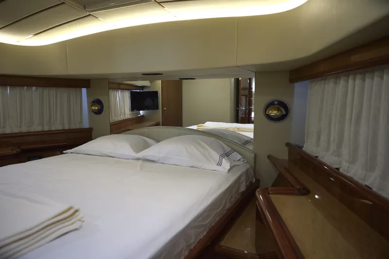  Yacht Photos Pics Luxurious bedroom interior of 2004 Ferretti Yachts 680 with elegant bedding and ambient lighting.
