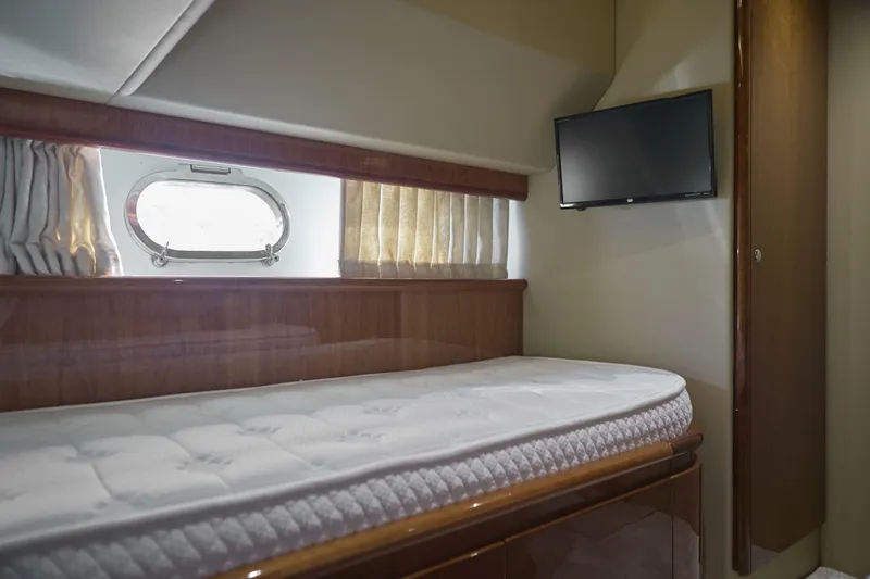  Yacht Photos Pics Luxurious cabin interior of 2004 Ferretti Yachts 680 with bed and TV.