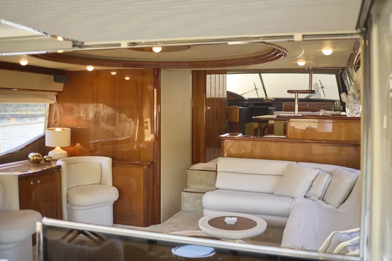  Yacht Photos Pics Luxurious interior of 2004 Ferretti Yachts 680, featuring elegant seating and polished wood finishes.