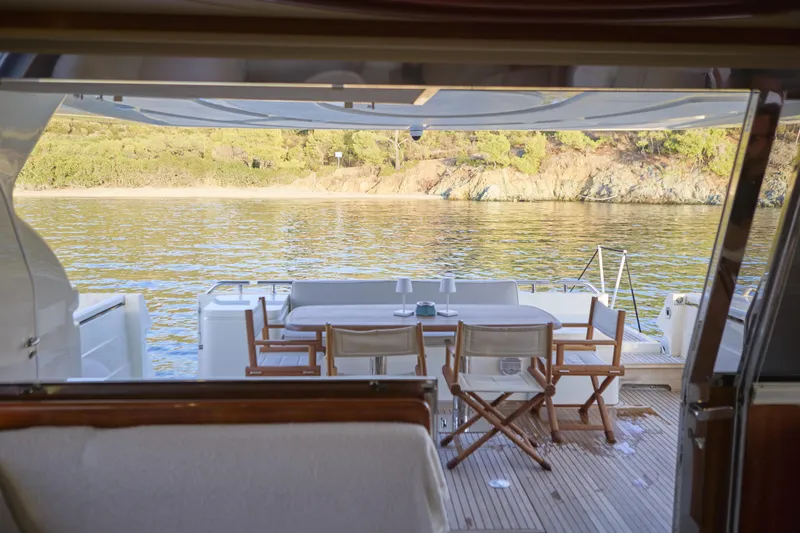  Yacht Photos Pics Luxurious 2004 Ferretti Yachts 680 with elegant outdoor dining area overlooking serene waters.