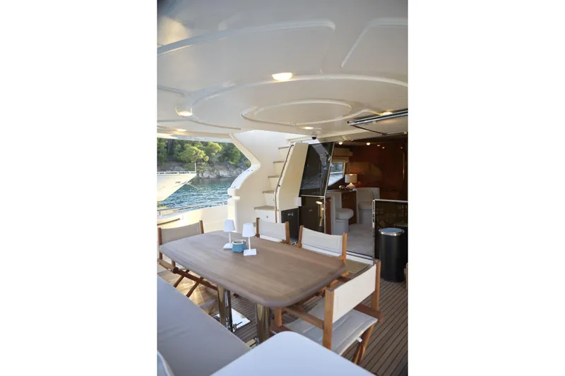  Yacht Photos Pics Luxurious 2004 Ferretti Yachts 680 with elegant outdoor dining area and scenic ocean view.