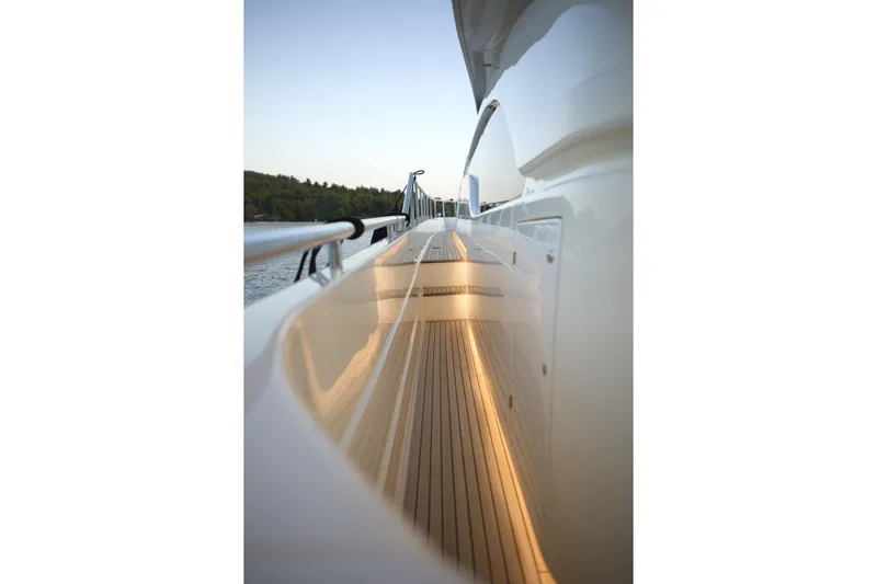  Yacht Photos Pics Side view of 2004 Ferretti Yachts 680, showcasing sleek deck design and railing.