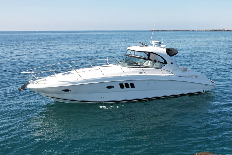 Knock On Wood Yacht Photos Pics 2008 Sea Ray 38 Sundancer yacht cruising on calm blue waters.