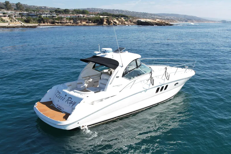 Knock On Wood Yacht Photos Pics 2008 Sea Ray 38 Sundancer yacht cruising near scenic coastline.