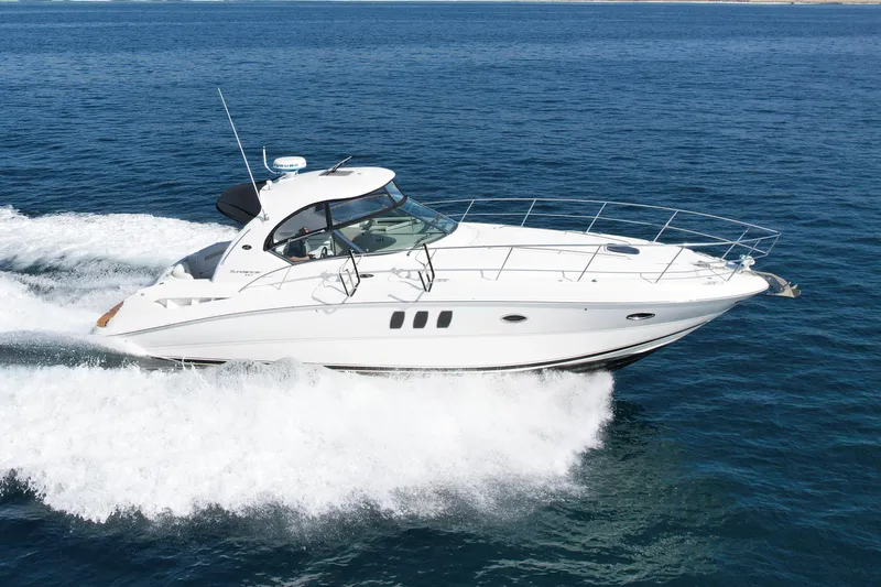 Knock On Wood Yacht Photos Pics 2008 Sea Ray 38 Sundancer cruising on open water, showcasing sleek design and performance.