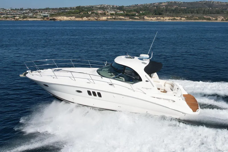 Knock On Wood Yacht Photos Pics 2008 Sea Ray 38 Sundancer cruising on open water, showcasing sleek design and performance.