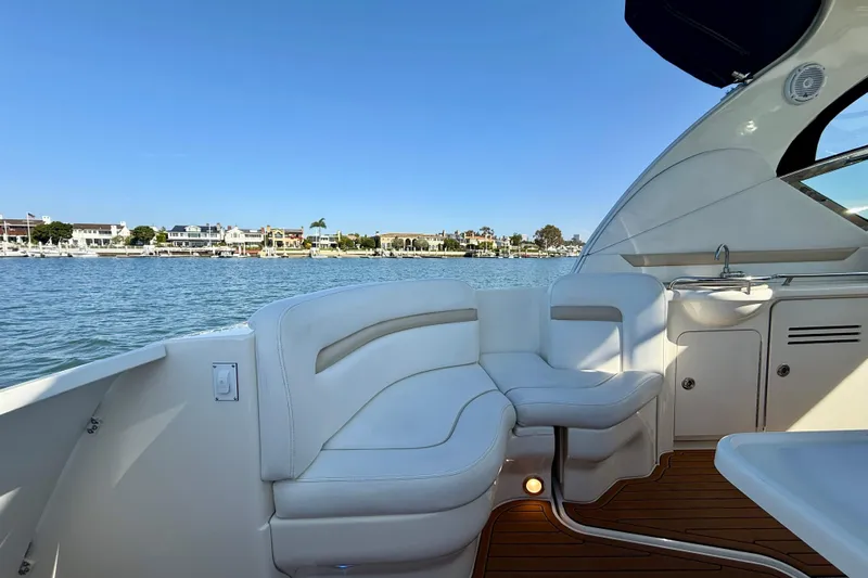 Knock On Wood Yacht Photos Pics 2008 Sea Ray 38 Sundancer yacht interior with white seating and waterfront view.