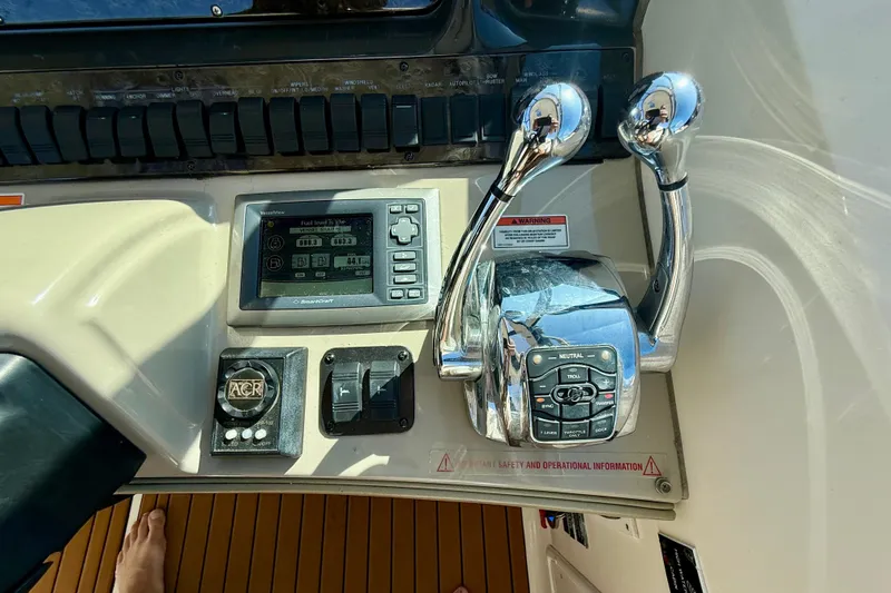 Knock On Wood Yacht Photos Pics Control panel of a 2008 Sea Ray 38 Sundancer boat with throttle levers and display.