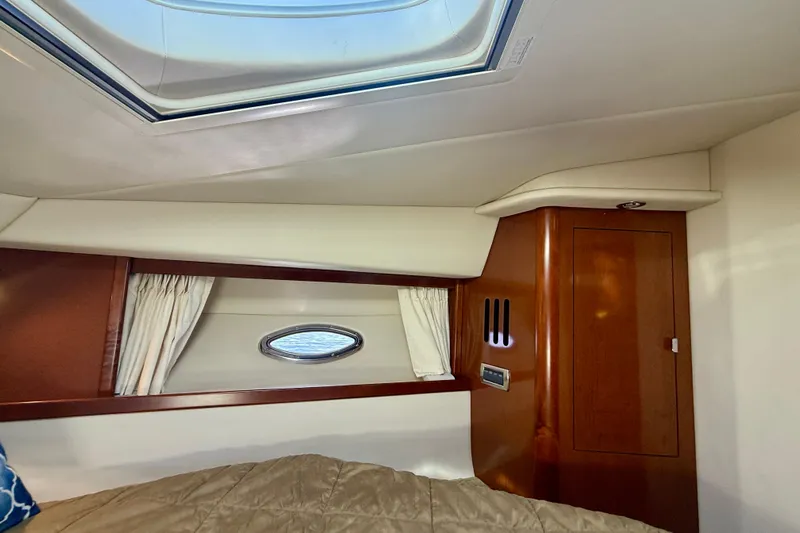 Knock On Wood Yacht Photos Pics Interior cabin of 2008 Sea Ray 38 Sundancer yacht with skylight and wood paneling.