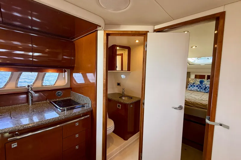 Knock On Wood Yacht Photos Pics Interior of 2008 Sea Ray 38 Sundancer yacht with kitchen, bathroom, and bedroom.