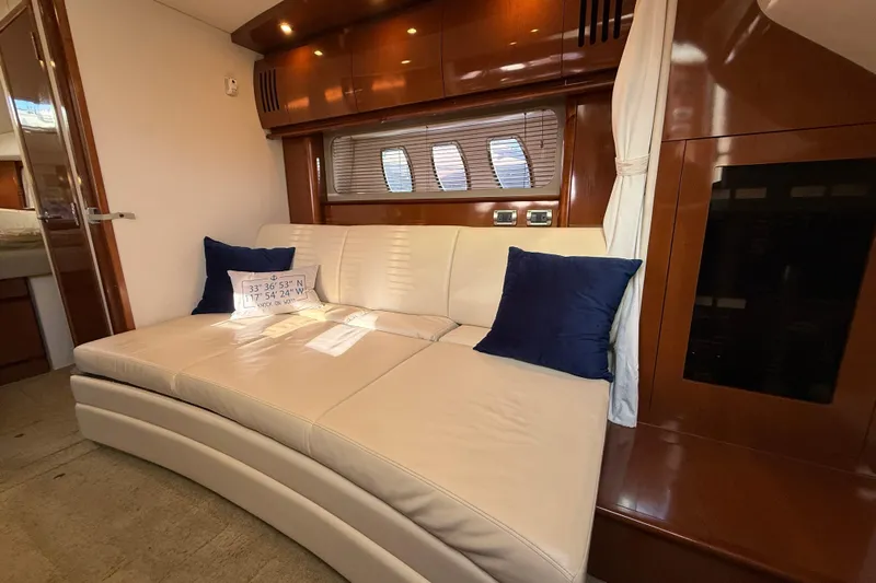 Knock On Wood Yacht Photos Pics Luxurious interior of 2008 Sea Ray 38 Sundancer with cream leather sofa and blue cushions.