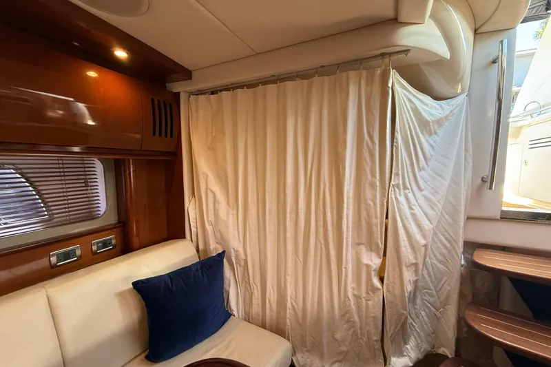 Knock On Wood Yacht Photos Pics Interior of 2008 Sea Ray 38 Sundancer yacht with curtain and seating area.