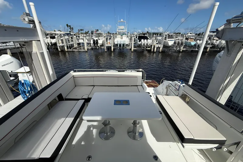  Yacht Photos Pics 2022 Jeanneau Leader 10.5 WA Series 2 boat interior with seating and table, docked at marina.