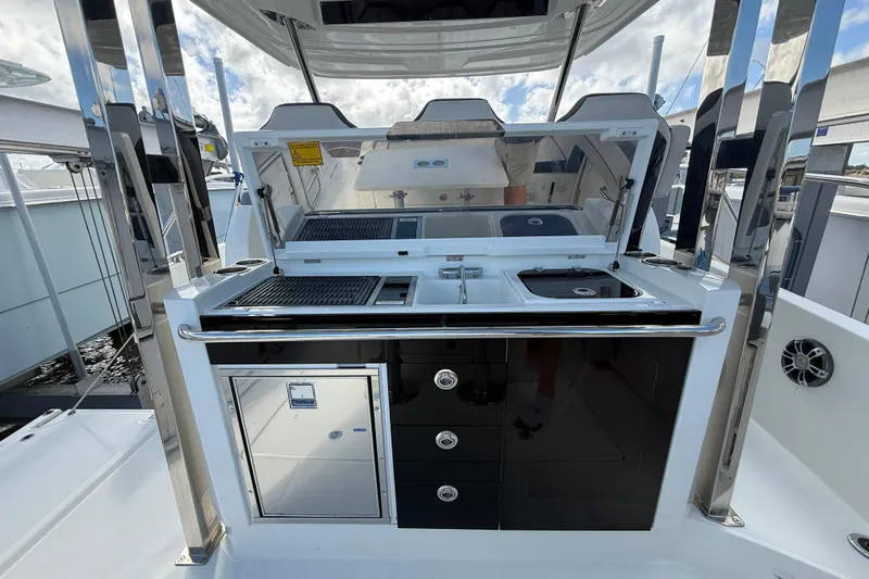  Yacht Photos Pics 2022 Jeanneau Leader 10.5 WA Series 2 boat kitchen with grill and sink.