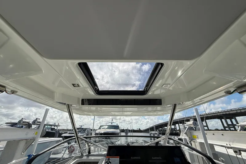  Yacht Photos Pics 2022 Jeanneau Leader 10.5 WA Series 2 boat interior with sunroof and navigation equipment.