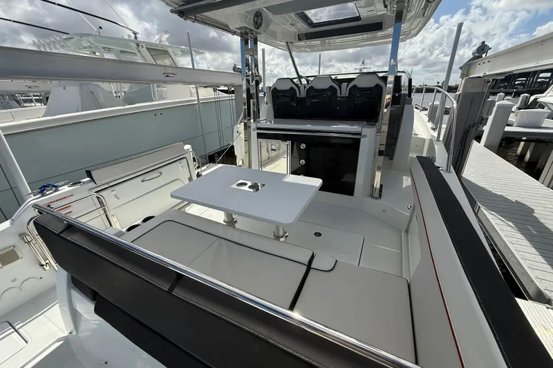 Yacht Photos Pics 2022 Jeanneau Leader 10.5 WA Series 2 boat interior with seating and table.
