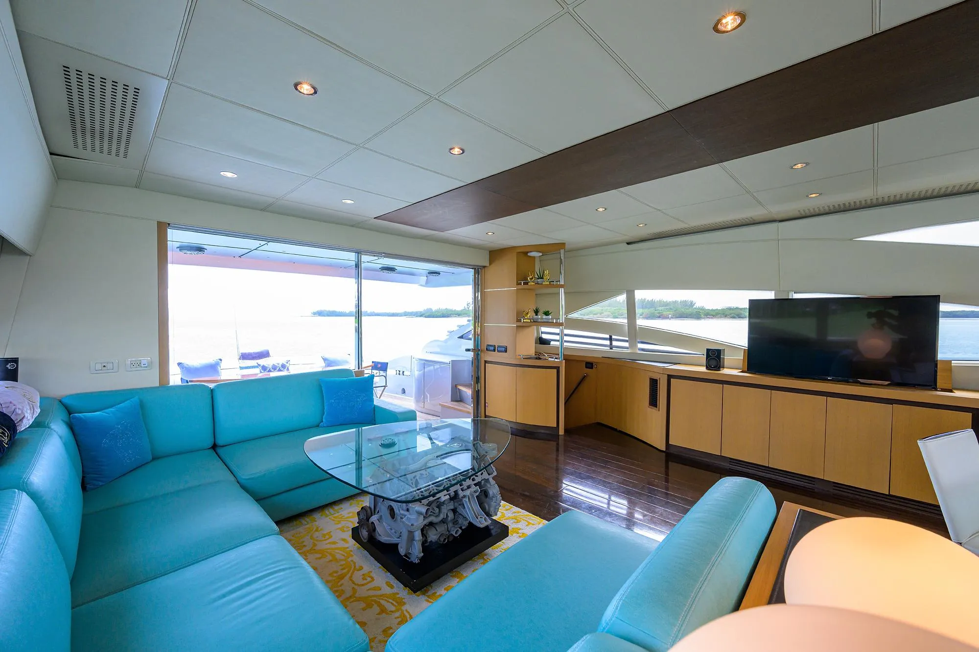Luxurious interior of 2009 Pershing 90 Express yacht with modern furnishings and large windows.