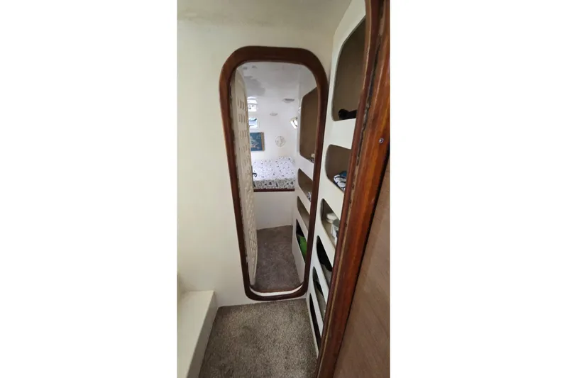  Yacht Photos Pics Interior view of 2018 Custom Len Jenkins 50 yacht, featuring cozy hallway and storage shelves.