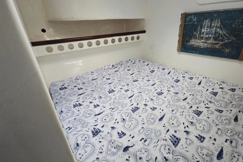  Yacht Photos Pics Cozy cabin interior of 2018 Custom Len Jenkins 50 with nautical-themed bedding.