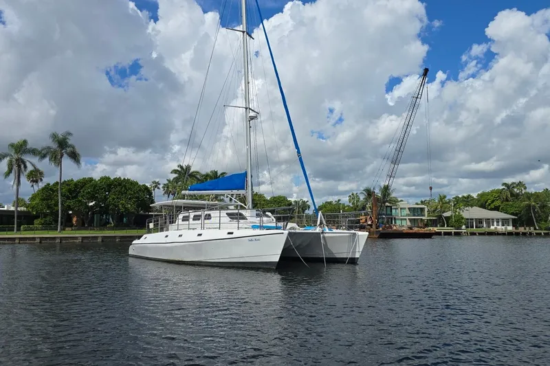  Yacht Photos Pics Sailing catamaran "Len Jenkins 50" anchored in a scenic waterfront location, 2018.