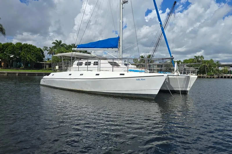  Yacht Photos Pics Custom Len Jenkins 50 catamaran, 2018 model, anchored on a calm waterway under a cloudy sky.