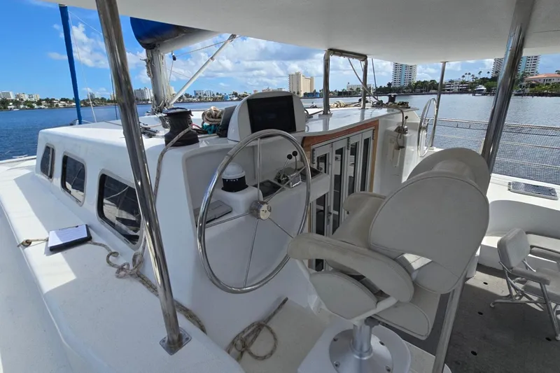  Yacht Photos Pics Custom Len Jenkins 50 yacht cockpit with steering wheel and seating, docked by waterfront.