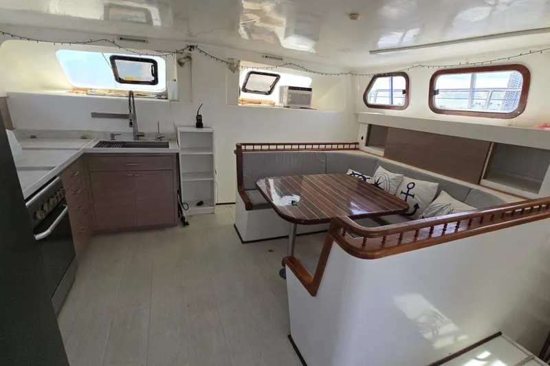  Yacht Photos Pics Interior of 2018 Custom Len Jenkins 50 yacht with modern kitchen and cozy seating area.