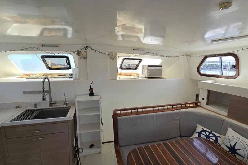  Yacht Photos Pics Interior of 2018 Custom Len Jenkins 50 yacht with modern kitchen and seating area.