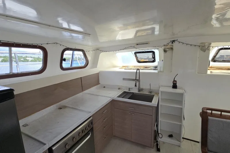  Yacht Photos Pics Interior of 2018 Custom Len Jenkins 50 yacht with modern kitchen and ample natural light.