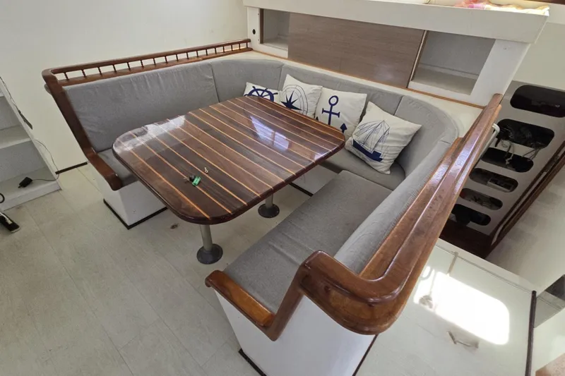  Yacht Photos Pics Cozy dining area on 2018 Custom Len Jenkins 50 yacht with nautical-themed cushions.
