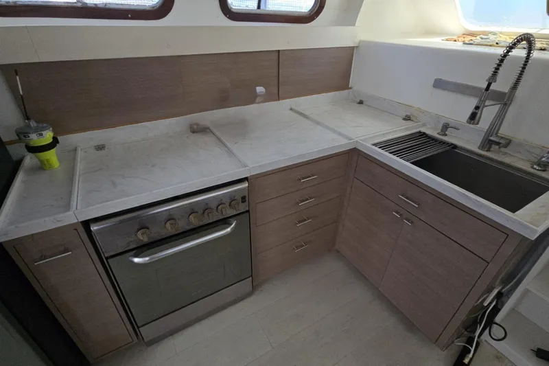  Yacht Photos Pics Modern yacht kitchen with marble countertops, stainless steel appliances, and sleek cabinetry in a 2018 Len Jenkins 50.