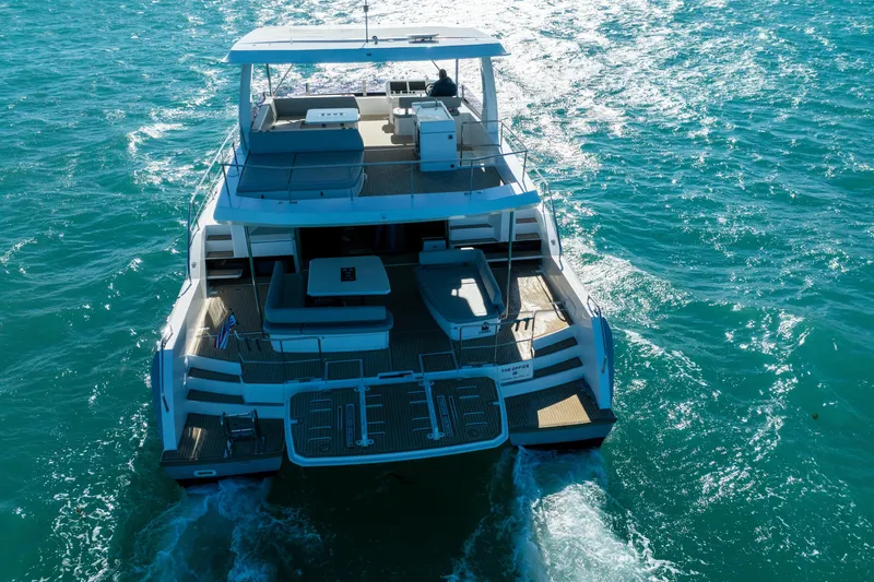 The Office Yacht Photos Pics Aerial view of 2021 Leopard 53 Powercat yacht cruising on blue ocean waters.