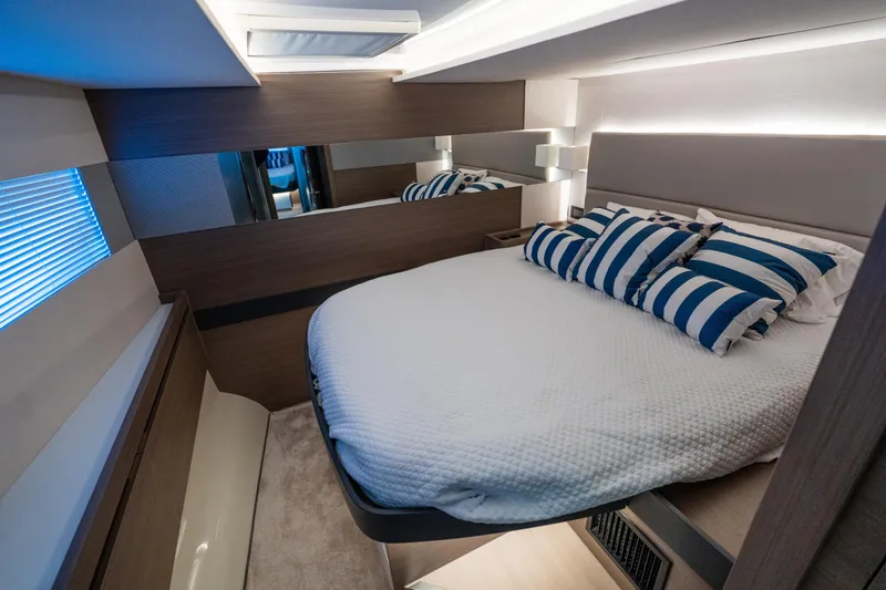 The Office Yacht Photos Pics Luxurious bedroom interior of 2021 Leopard 53 Powercat yacht with striped pillows.