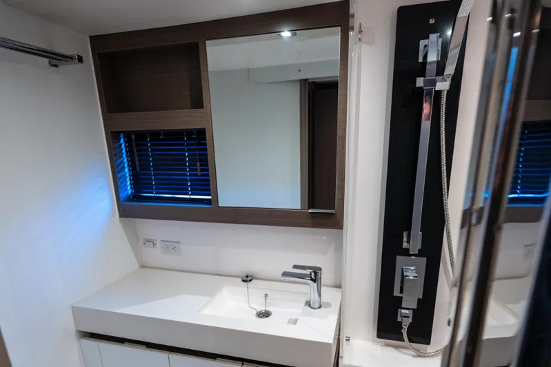 The Office Yacht Photos Pics Modern bathroom interior of 2021 Leopard 53 Powercat yacht, featuring sleek sink and mirror.