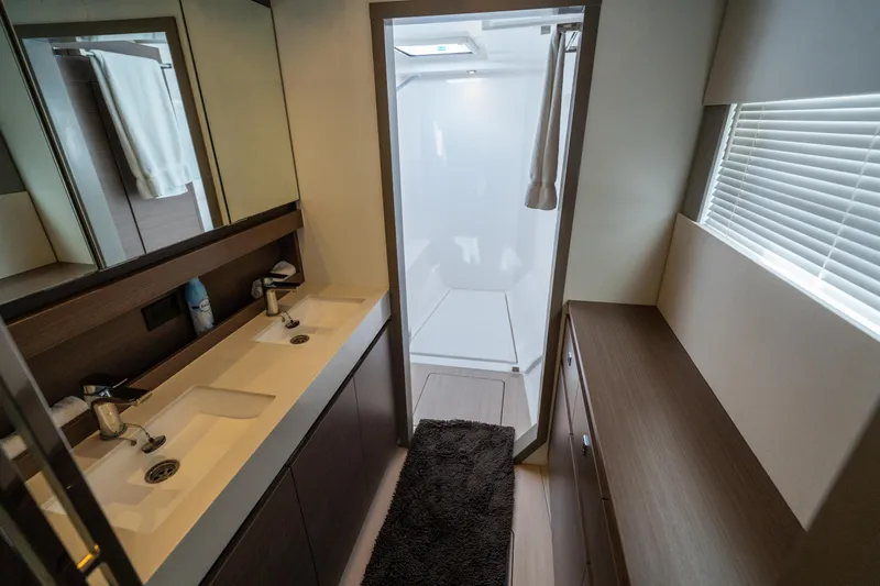 The Office Yacht Photos Pics Modern bathroom interior of 2021 Leopard 53 Powercat yacht, featuring dual sinks and shower.