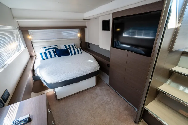 The Office Yacht Photos Pics Luxurious bedroom interior of 2021 Leopard 53 Powercat yacht with modern design and cozy bedding.