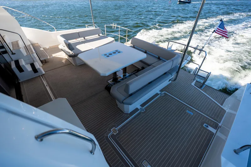 The Office Yacht Photos Pics Spacious deck of 2021 Leopard 53 Powercat yacht with seating and ocean view.