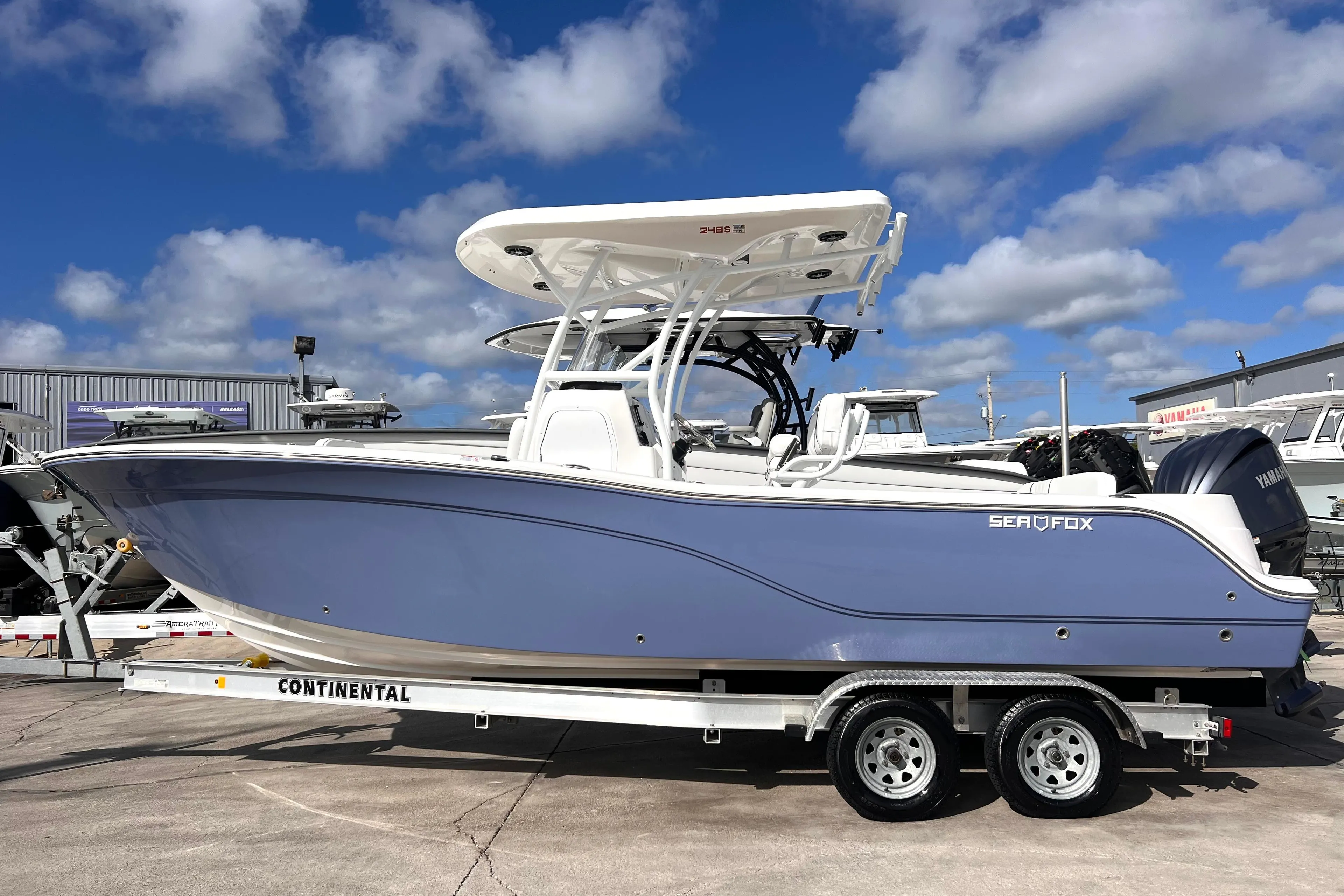2025 Sea Fox 248 Side Console boat on trailer under blue sky.