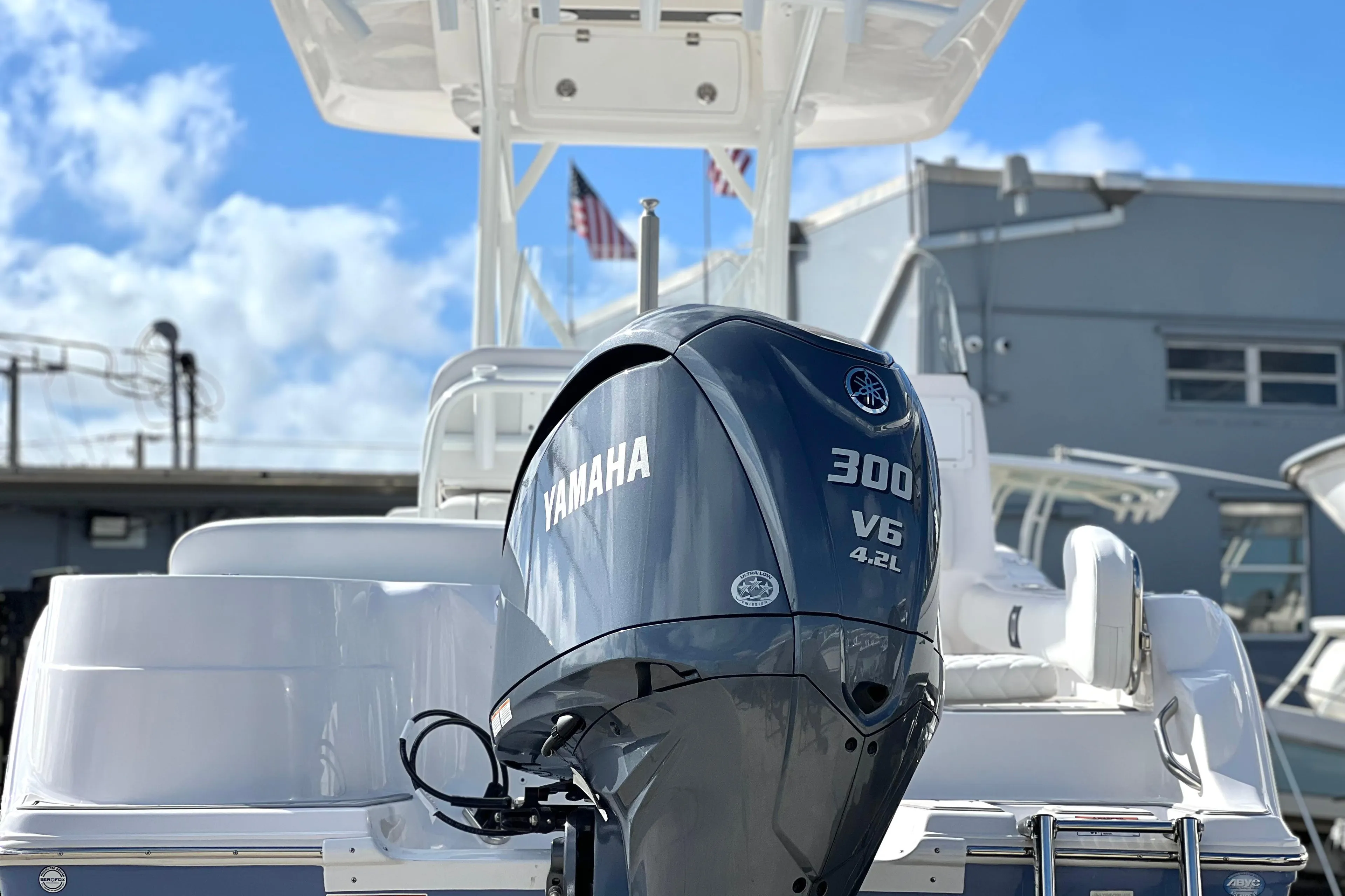 2025 Sea Fox 248 Side Console boat with Yamaha 300 V6 engine, docked under blue sky.