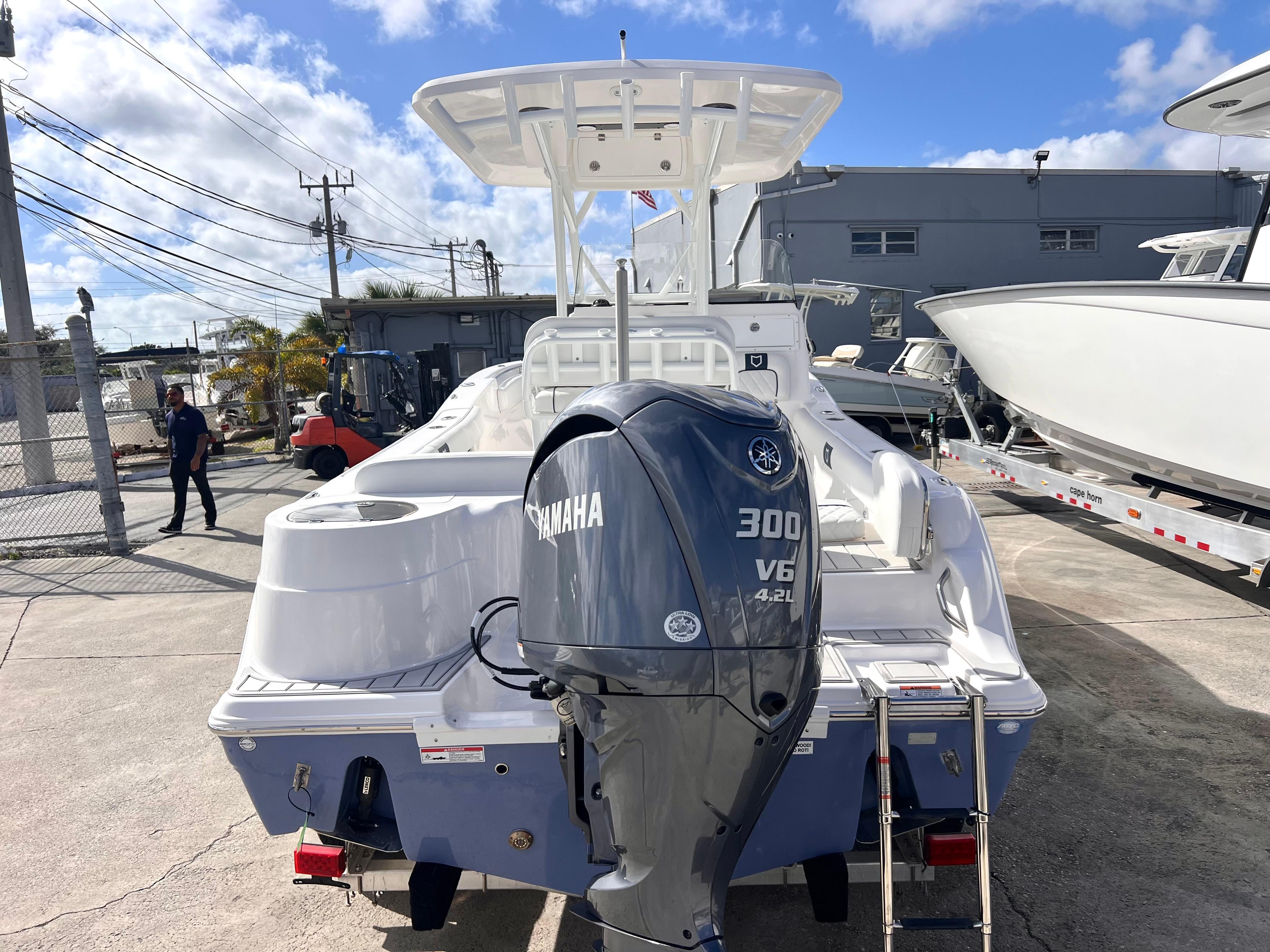 2025 Sea Fox 248 Side Console boat with Yamaha 300 V6 engine, docked outdoors.