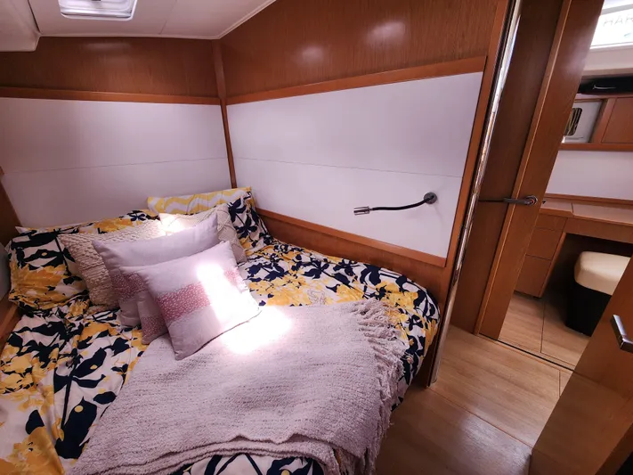 Jump Off Yacht Photos Pics Cozy bedroom in 2011 Beneteau Sense 50 yacht with floral bedding and wooden interior.