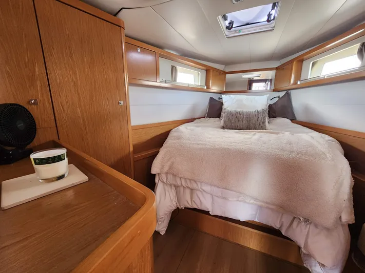Jump Off Yacht Photos Pics Cozy bedroom interior of 2011 Beneteau Sense 50 yacht with wooden cabinetry and skylight.