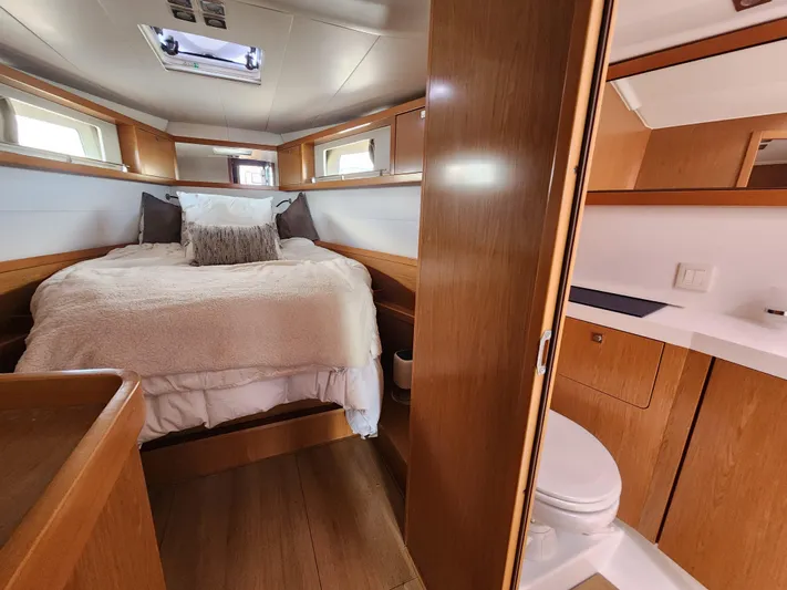 Jump Off Yacht Photos Pics Luxurious 2011 Beneteau Sense 50 yacht cabin with cozy bed and modern bathroom.
