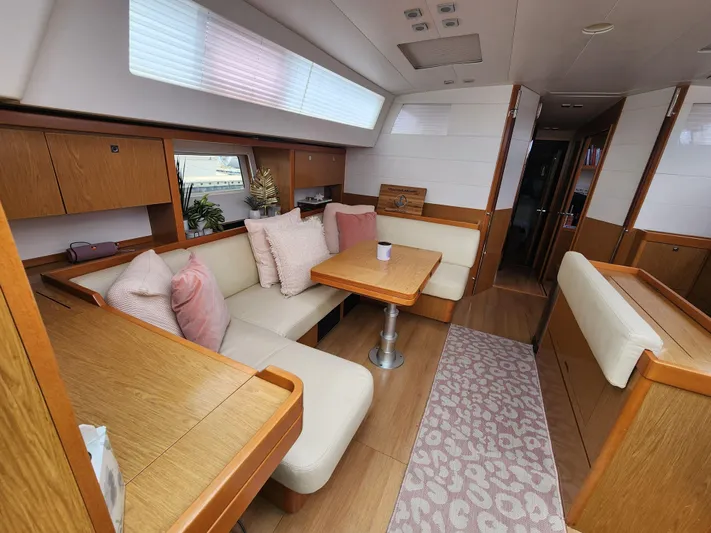 Jump Off Yacht Photos Pics Interior of 2011 Beneteau Sense 50 yacht with cozy seating and wooden finishes.