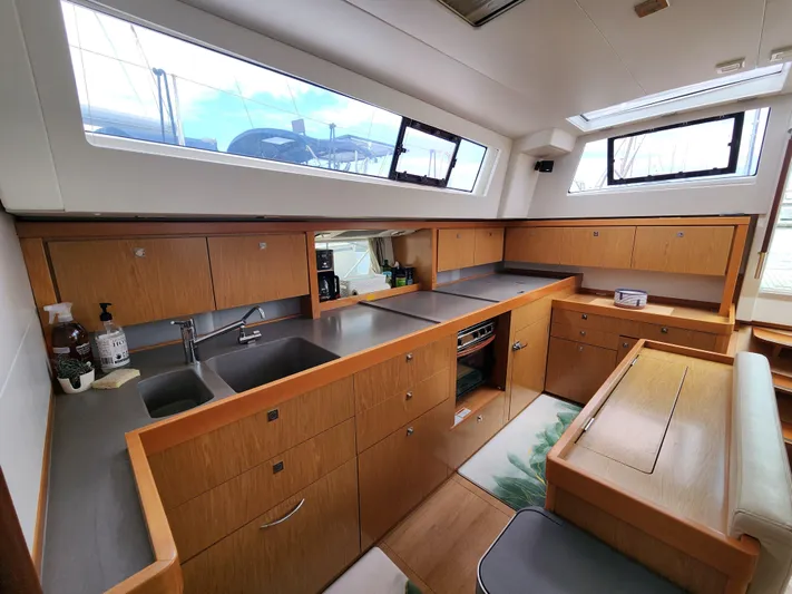 Jump Off Yacht Photos Pics Interior of 2011 Beneteau Sense 50 yacht with modern kitchen and ample natural light.