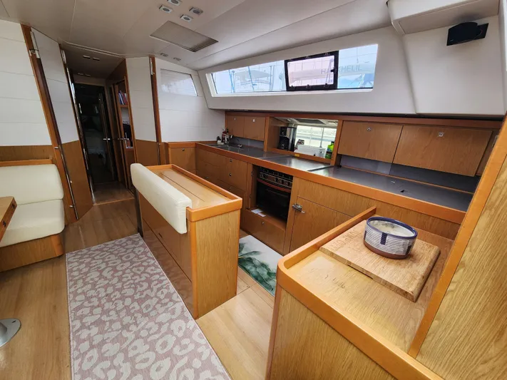Jump Off Yacht Photos Pics Interior of 2011 Beneteau Sense 50 yacht, featuring modern kitchen and seating area.