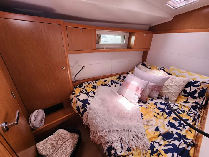 Jump Off Yacht Photos Pics Cozy cabin interior of 2011 Beneteau Sense 50 yacht with floral bedding and wooden cabinetry.