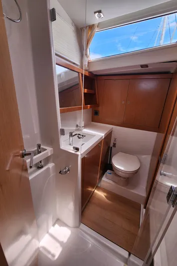 Jump Off Yacht Photos Pics Beneteau Sense 50 2011 yacht bathroom with modern fixtures and wooden accents.