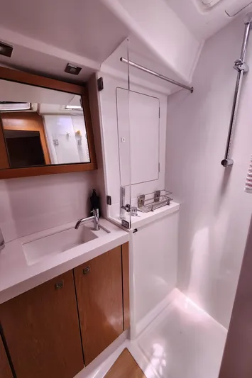 Jump Off Yacht Photos Pics Beneteau Sense 50 2011 yacht bathroom with modern fixtures and wooden cabinetry.
